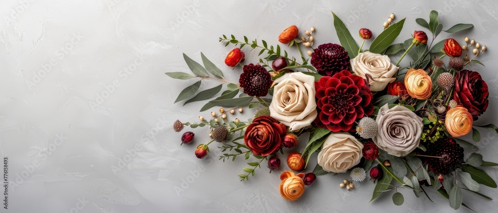   A tight shot of an array of flowers against a pristine white background, showcasing their leaves and blooms atop it