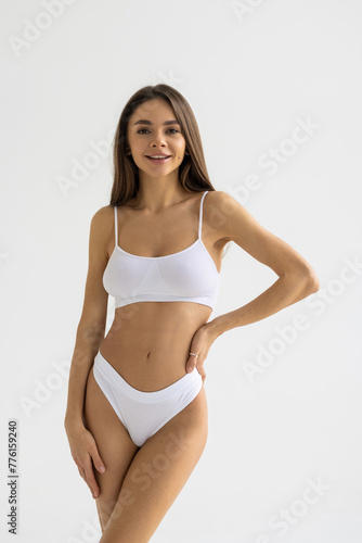 Close up shot of a fit woman in lingerie isolated on white background.