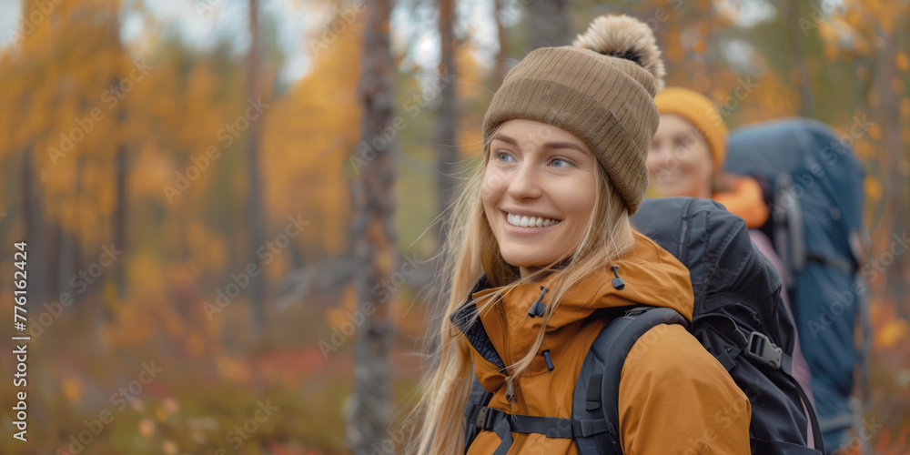 Woman and her friend are hiking with backpack in autumn forest Woman and her friend are hiking with backpack in autumn forest