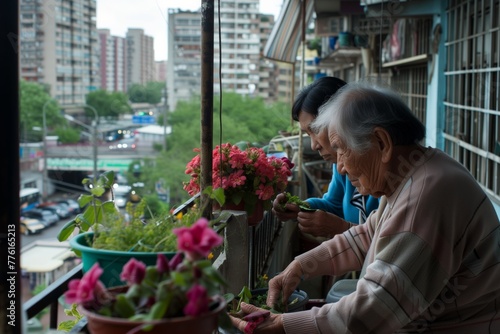 Elderly duo tending balcony garden, urban backdrop contrasting gentle activity, immersed in horticultural care. Senior gardeners on an apartment balcony nurture plants, a cityscape unfurls behind