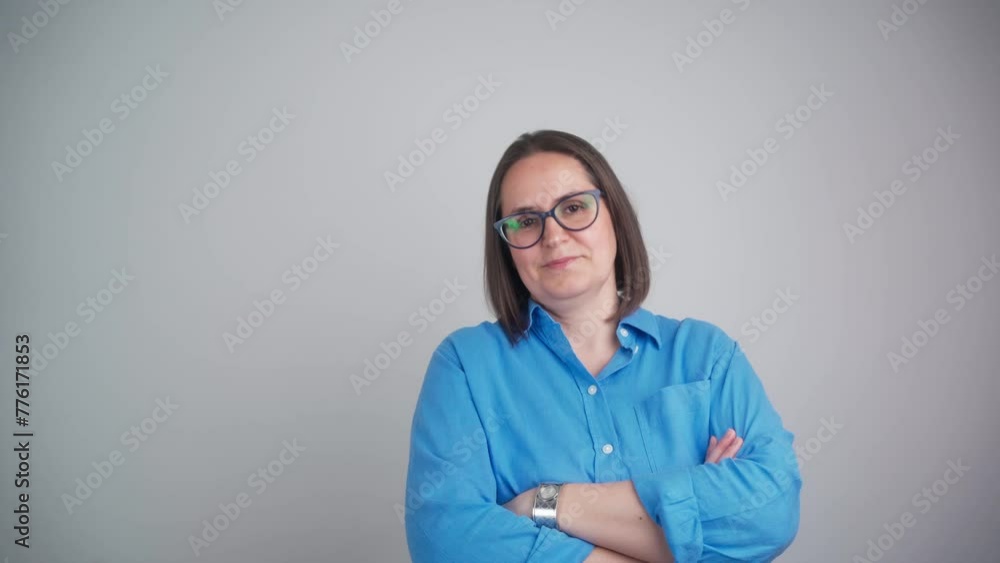 portrait of confident serious american business woman standing with arms crossed looking at camera. indoors. Independent female teacher or associate professor with glasses isolated portrait of confident serious american business woman standing with arms crossed looking at camera. indoors. Independent female teacher or associate professor with glasses isolated