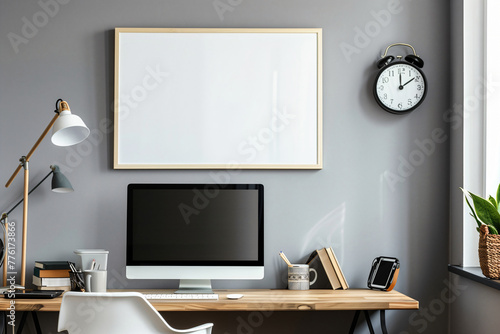 photo of an empty frame on the wall above desktop computer