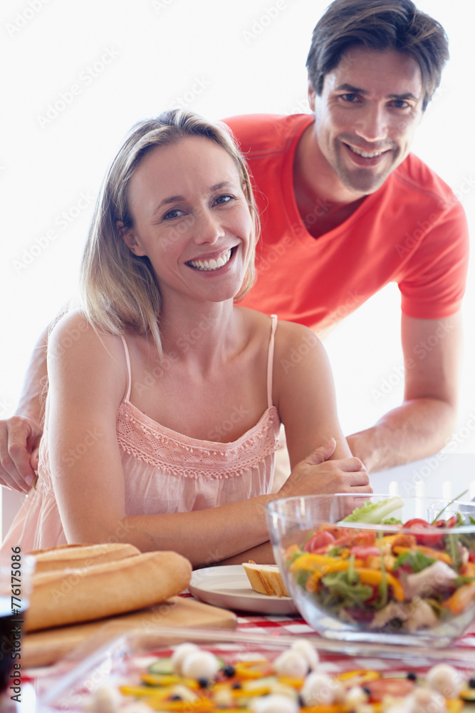 Portrait, couple and living room with salad at table eating together for lunch. Married, man and woman on romantic honeymoon at house sitting in lounge with vegetables on diet for healthy wellbeing