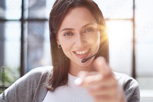 call center operator woman pointing with finger to the camera and to you, hand sign, positive and confident gesture from the front