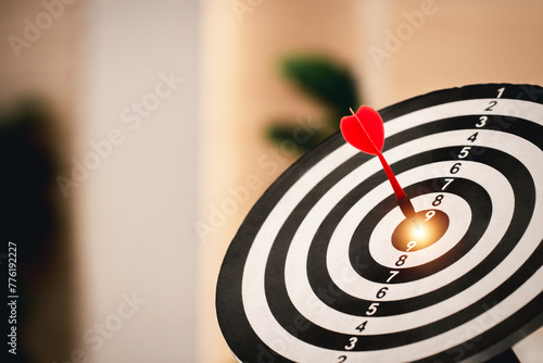 Red dart hitting on the target center dartboard, Business targeting or goal success and winner concept, Represent a challenge in business marketing as concept.