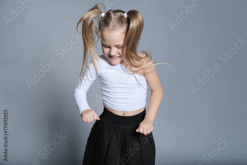 Little dancer moves with glee, pigtails flying. A moment that celebrates the vibrant energy and joyful spirit of childhood.