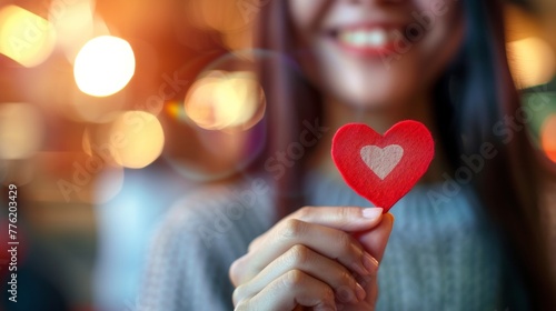 Heart shape in the hand of a female