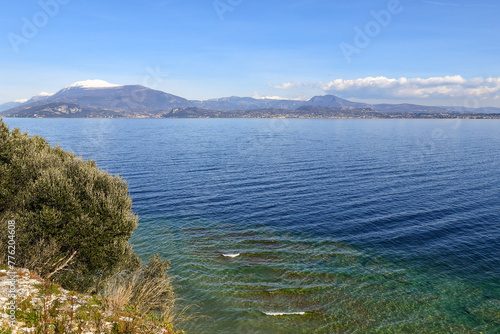 Elevated view of Lake Garda, famous tourist destination of Northern Italy, with the Monte Baldo alpine range in the background, Sirmione, Brescia, Lombardy, Italy
