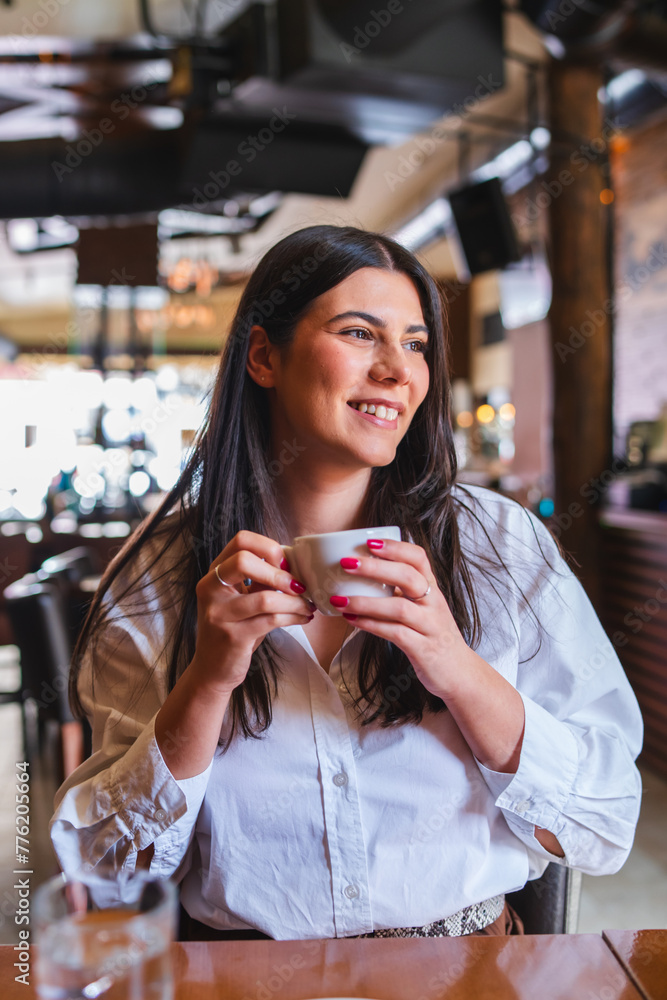 A one young girl or woman is drinking coffee in cafe or restaurant and enjoying her time
A one young girl or woman is drinking coffee in cafe or restaurant and enjoying her time