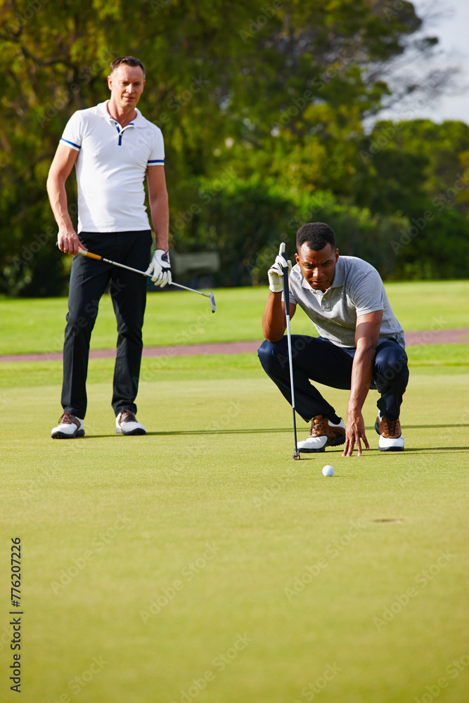 Men, play and aim golf ball at hole for sport, fitness or health in outdoor competition on summer day. People, watch and concentrate in tournament on green course for drive, hit and putt together