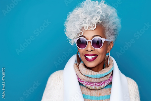 60 year old fashionable hipster African American woman portrait on blue background