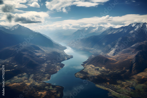 A beautiful river flowing between the mountains, bird's eye view, clouds in the sky