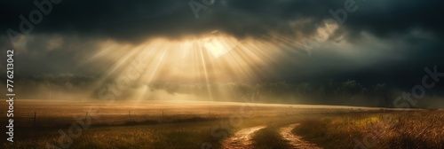 A breath-taking rural landscape where radiant sun rays break through ominous storm clouds illuminating a path on a field, symbolizing hope