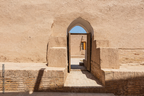 Doorway through an adobe wall in Khiva. photo