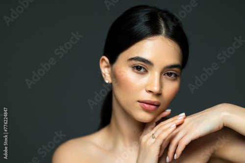 Portrait of young beautiful woman with perfect smooth skin isolated over white background.