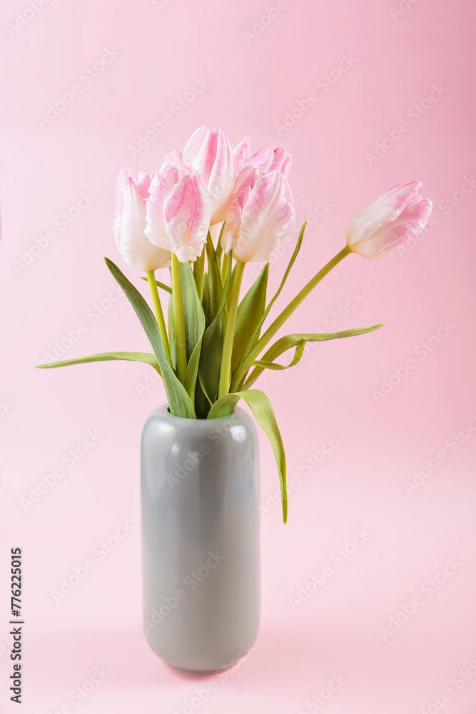 Beautiful pink tulips in vase on pastel pink background. Hello spring greeting or invitation card. Beautiful pink tulips in vase on pastel pink background. Hello spring greeting or invitation card.