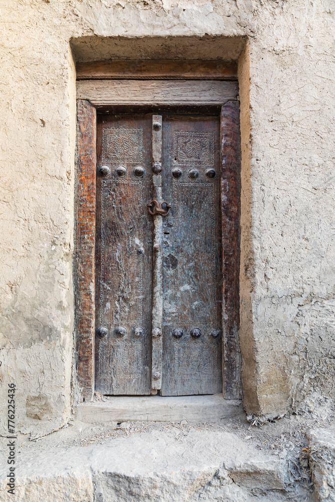 An old wooden door on an adobe building in Bukhara.