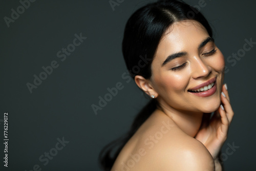 Portrait of young beautiful woman with perfect smooth skin isolated over white background.
