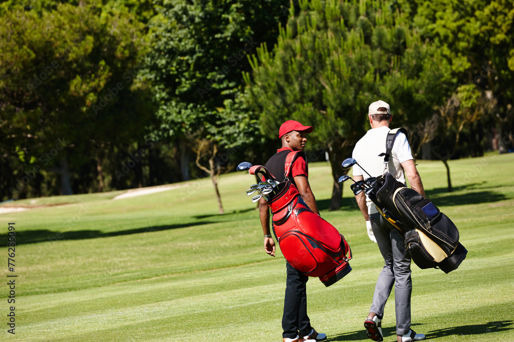 Fototapeta premium People, walking and outdoor on course for golf, game and training at club in summer. Golfer, friends and men on grass turf in park together talking about practice of sport with healthy competition