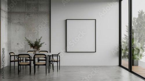 A minimalist dining area with a spacious  unadorned wall featuring a single  oversized blank photo frame  accompanied by a sleek dining table set.