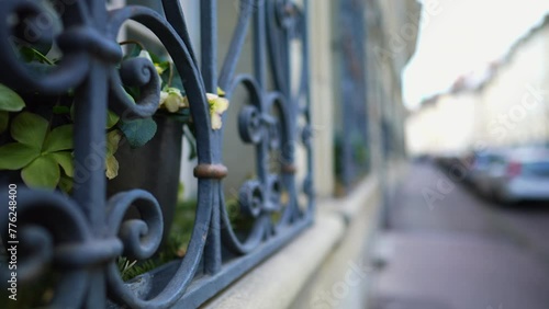 European Sidewalk Framed by Elegant Window Security metal gate demarcating property protection photo