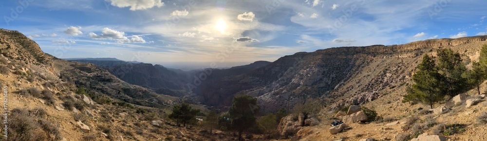 Panorama landscape view of Wadi Dana a large natural canyon, Wadi Araba. Dana Biosphere Reserve Dana village near the city of Tafilah,Feynan area in central-western Jordan.Dana valley ecotourism Panorama landscape view of Wadi Dana a large natural canyon, Wadi Araba. Dana Biosphere Reserve Dana village near the city of Tafilah,Feynan area in central-western Jordan.Dana valley ecotourism