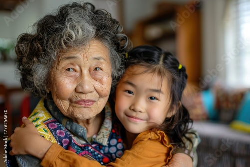 Asian old woman grandmother with granddaughter. Family. Generations. Elderly Person's Day. Chinese New Year. TET