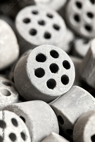 Carbon dioxide reforming of methane nickel catalyst seven holes cylinder pellet form shape methanol synthesis industrial petrochemical selective focus close up vertical shot texture background.
