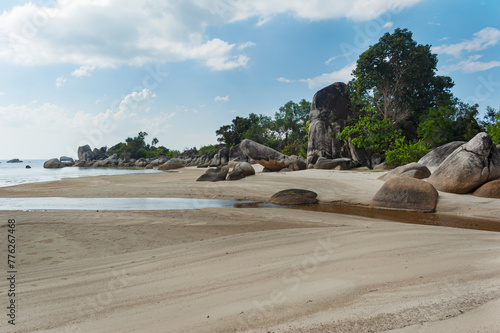 Fototapeta Naklejka Na Ścianę i Meble -  Beautiful beach with white sand with huge granite stones and a creek that flows into it. Surrounded by greenery near Tanjung Tinggi, Belitung, Sumatra, Indonesia.