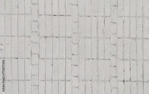 The wall is made of white brick, a natural material, stone masonry. Texture for indoor or outdoor background, interior.