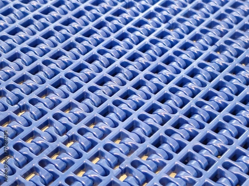 Obraz na płótnie A close-up of a blue polyurethane belt in modular industrial conveyor system. Transport systems in industrial factories. w salonie