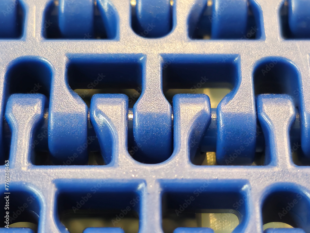 A close-up of a blue polyurethane belt in modular industrial conveyor system. Transport systems in industrial factories.