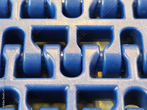 Obraz na płótnie A close-up of a blue polyurethane belt in modular industrial conveyor system. Transport systems in industrial factories. w salonie