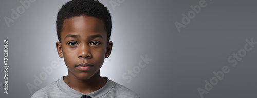 An African American Juvenile Boy, Isolated On A Silver Background With Copy Space photo