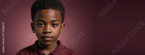 An African American Juvenile Boy, Isolated On A Ruby Background With Copy Space photo