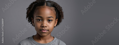 An African American Youngster Girl, Isolated On A Grey Background With Copy Space photo