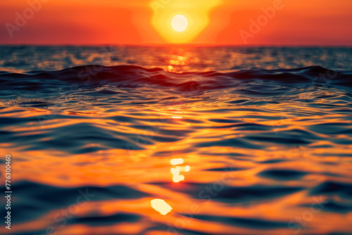 The sun is setting over the ocean, casting a warm glow on the water © Formoney
