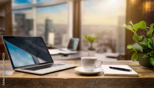 A modern office with a desk, computer and coffee in the center and a beautiful view of the skyscrapers from the window