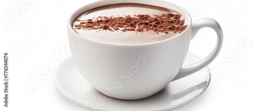 A steaming cup of hot chocolate with a silver spoon placed on a saucer, showcasing a cozy and comforting beverage option