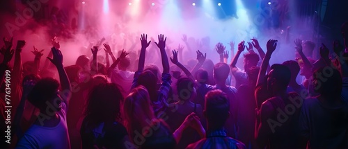 Youthful crowd dancing energetically to electronic beats in nightclub discotheque. Concept Nightclub Scene, Energetic Dancing, Electronic Beats, Youthful Crowd, Discotheque