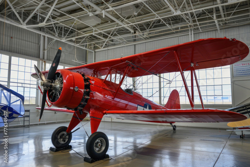 Vintage Aviation: Classic Red Biplane in an Aircraft Hangar photo