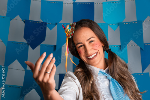 Brazilian Festa Junina, happy woman welcomes to traditional festival in costume.