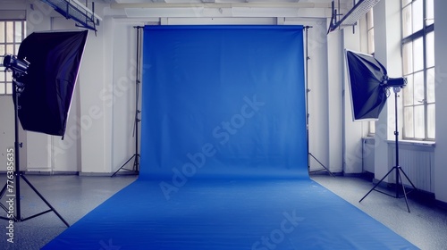 Professional photo studio setup with blue backdrop and lighting equipment. Photography studio portrait background. Design for workshop banners, photography tutorials and studio advertisements. photo