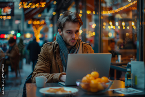 Man Sitting at Table With Laptop