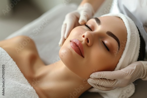 Woman enjoying facial massage at spa, feeling happy and relaxed