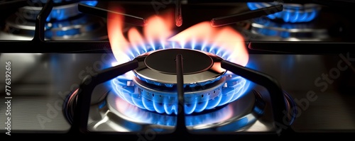 two kitchen gas stove burners, close up of blue flame,