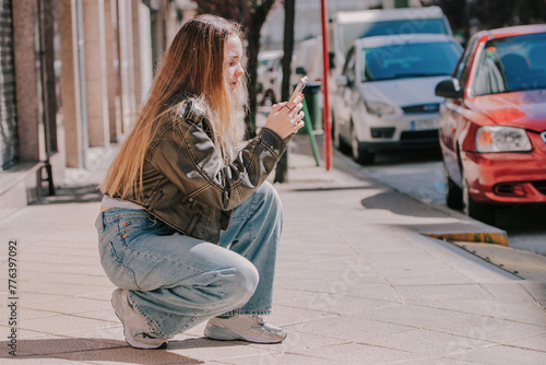 blonde girl on the street outdoors with mobile phone