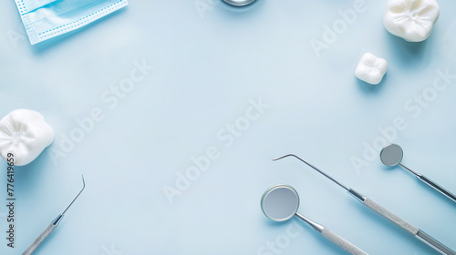 various dentist tools for dental care and white healthy tooth on a blue background. Dental background with copy space. prosthetics photo