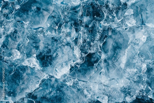 Textured background of blue ice on smooth surface of frozen lake water in winter in vatnajokull national park