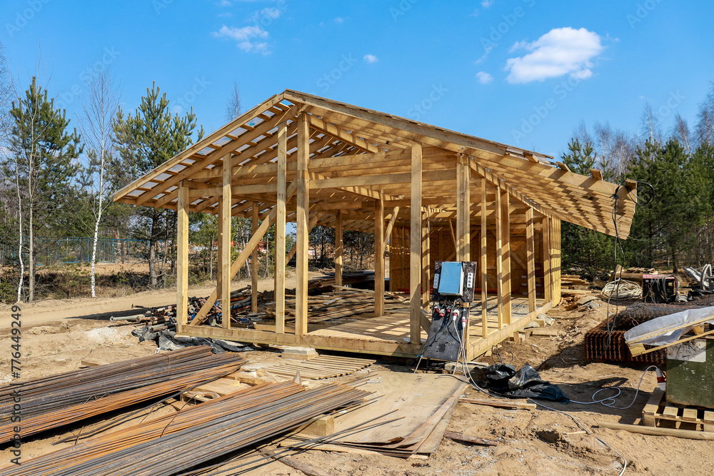 Construction of a house made of laminated veneer lumber. The frame of the house. Cottage made of laminated wood. Erection of the frame of the cottage. Manufacture of houses made of wood Construction of a house made of laminated veneer lumber. The frame of the house. Cottage made of laminated wood. Erection of the frame of the cottage. Manufacture of houses made of wood
